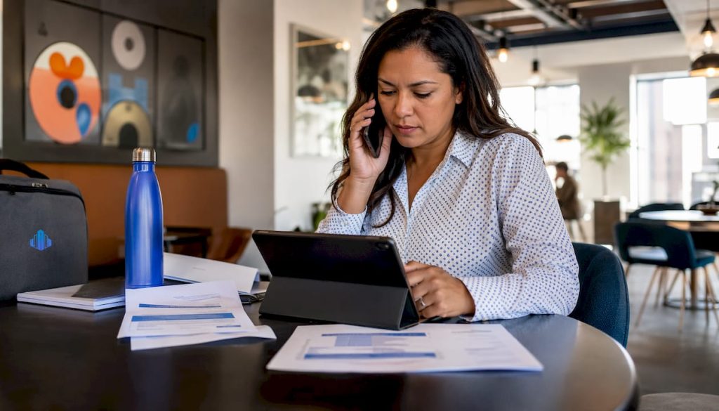 Lender speaking on phone reviewing loan documents