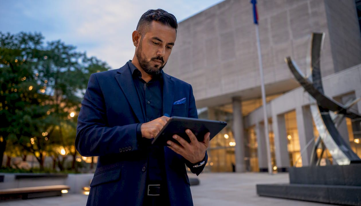 Man reviewing permit information on tablet in planning office
